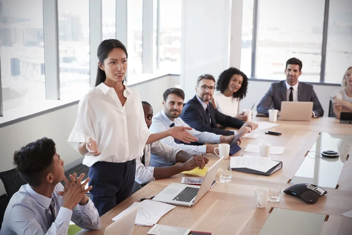 Mulher exercendo o que aprendeu sobre Comunicação estratégica para liderança feminina em reunião. 